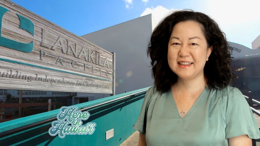 woman smiling in front of a building