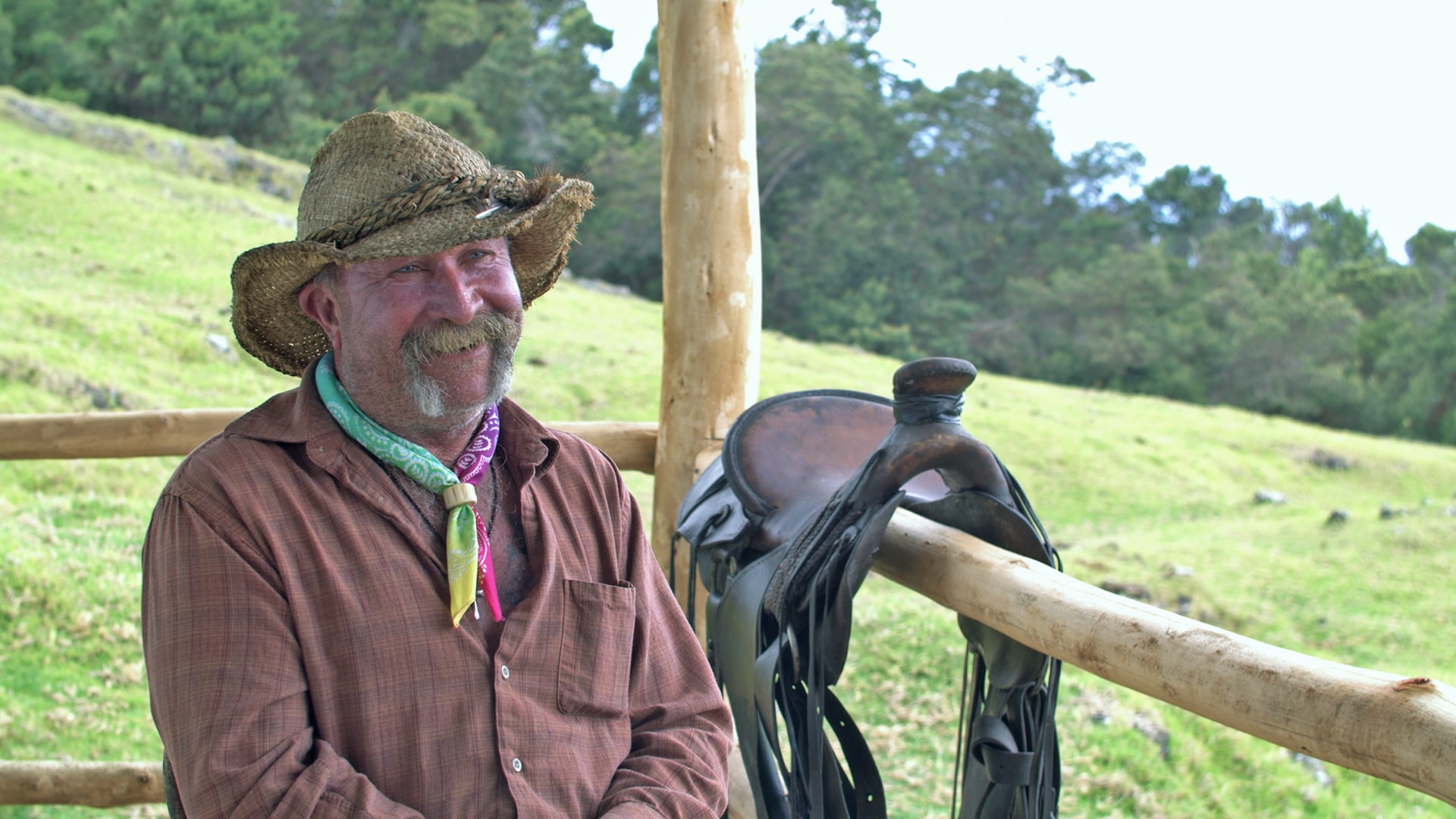 Man wearing a cowboy hat, smiling